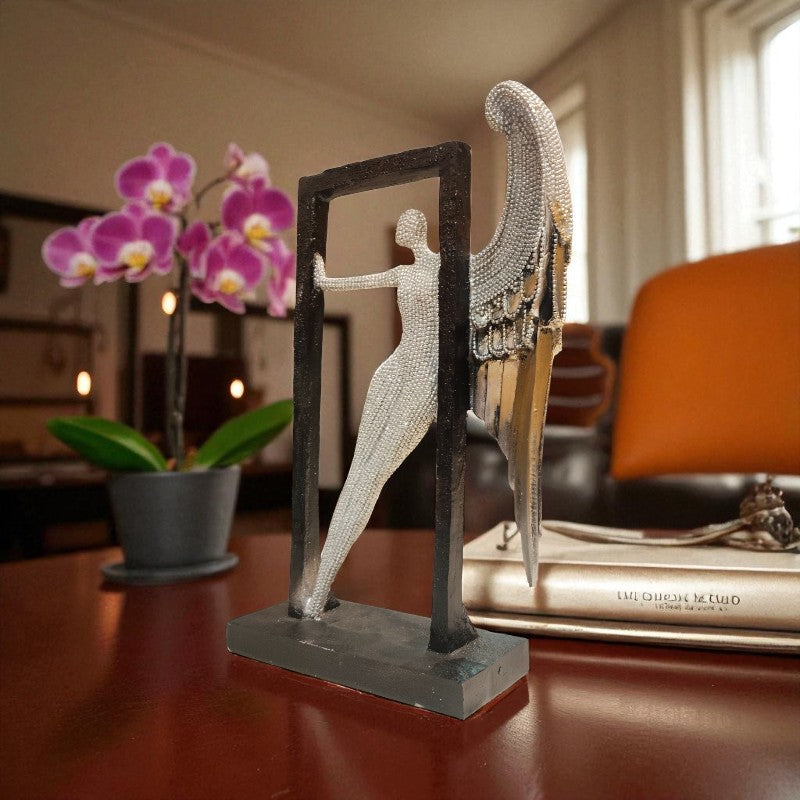 Decorative angel sculpture on a table with a blurred background