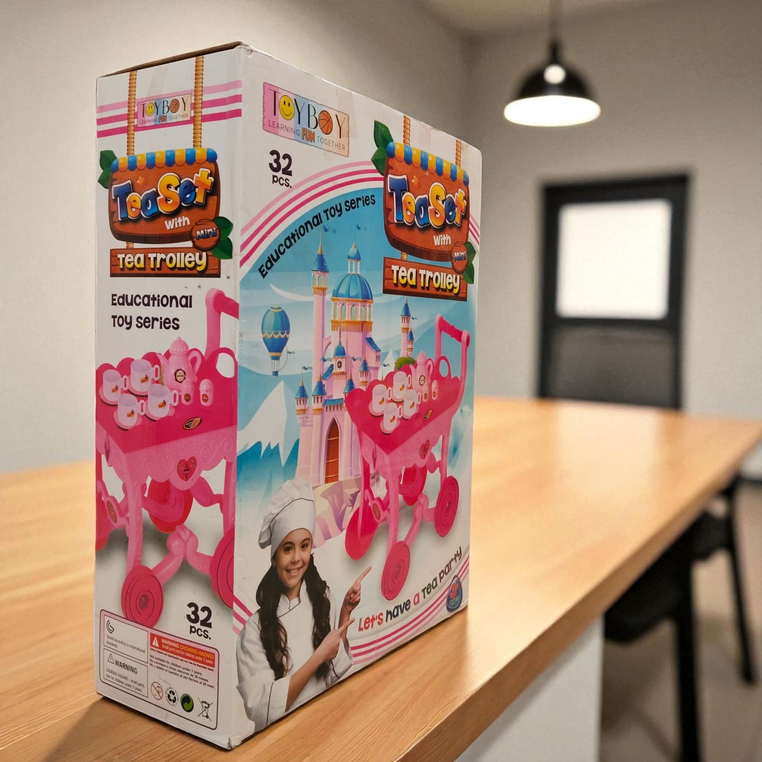  Angled view of Tea Set with Mini Tea Trolley packaging on wooden table in bright room