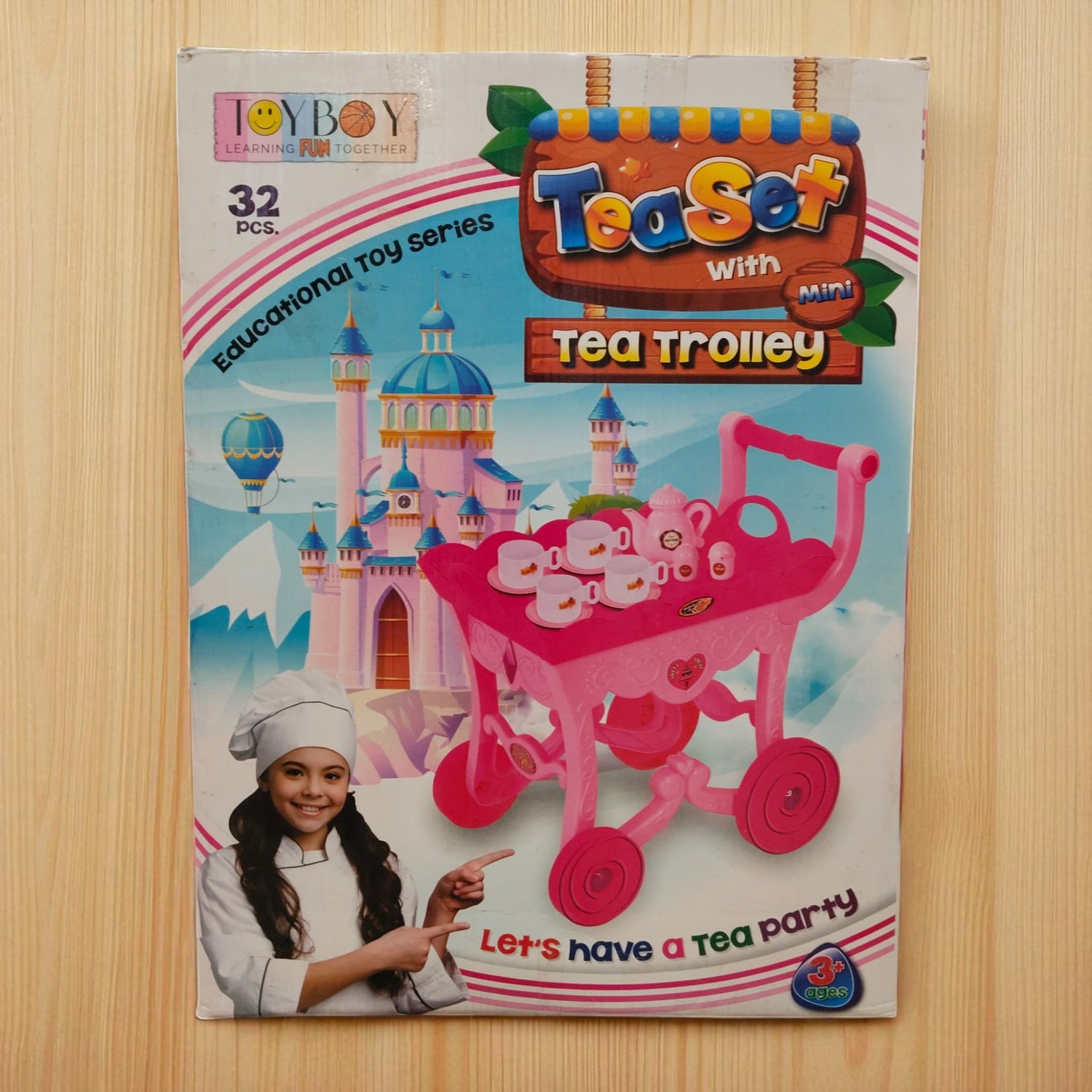 Front of Tea Set with Mini Tea Trolley box showing pink trolley and smiling girl in chef hat