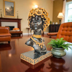 Decorative bust with floral headpiece on a table in a room with furniture and decor.
