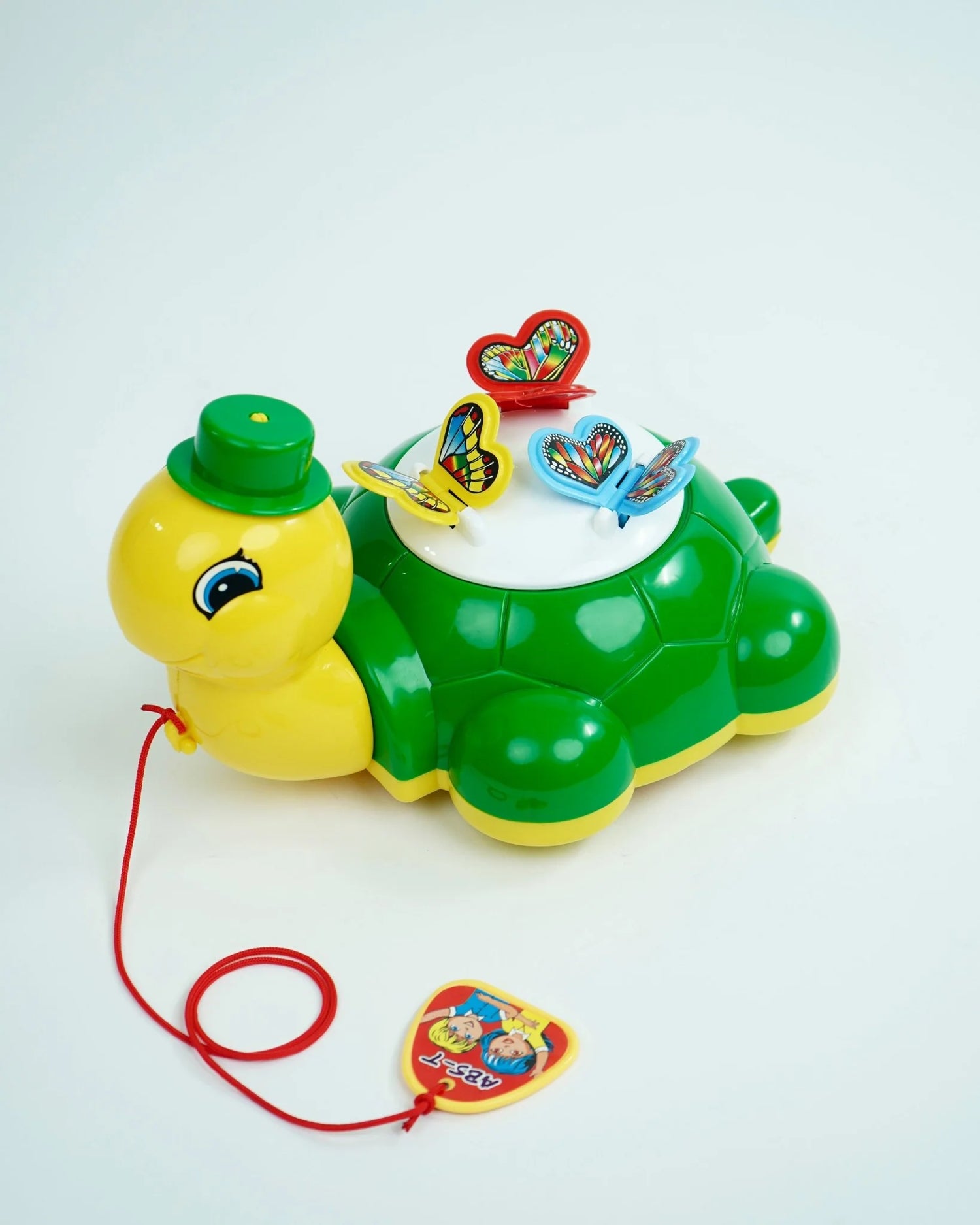 Toy turtle with colorful butterflies on a white background