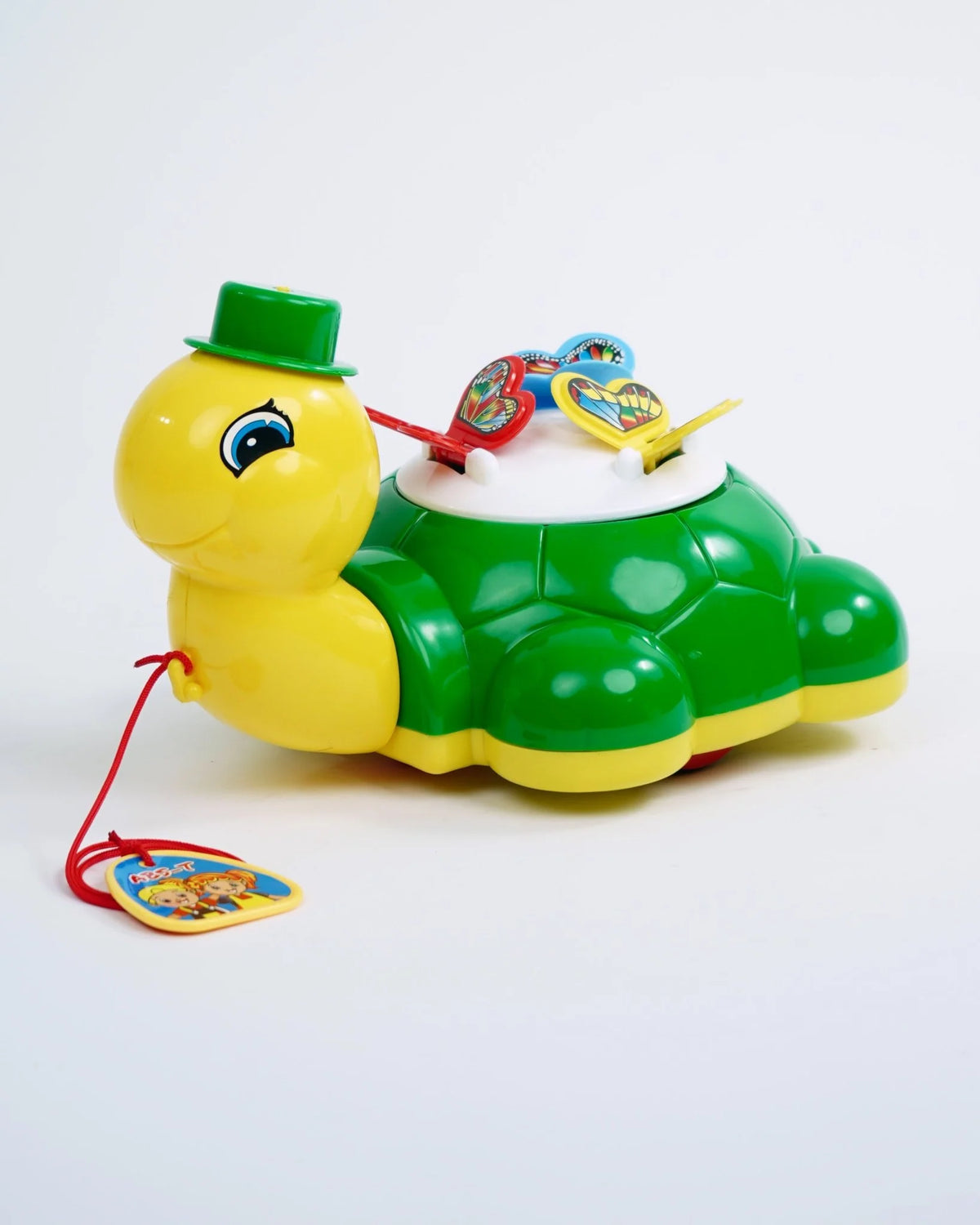 Toy turtle with a green hat and colorful details on a white background